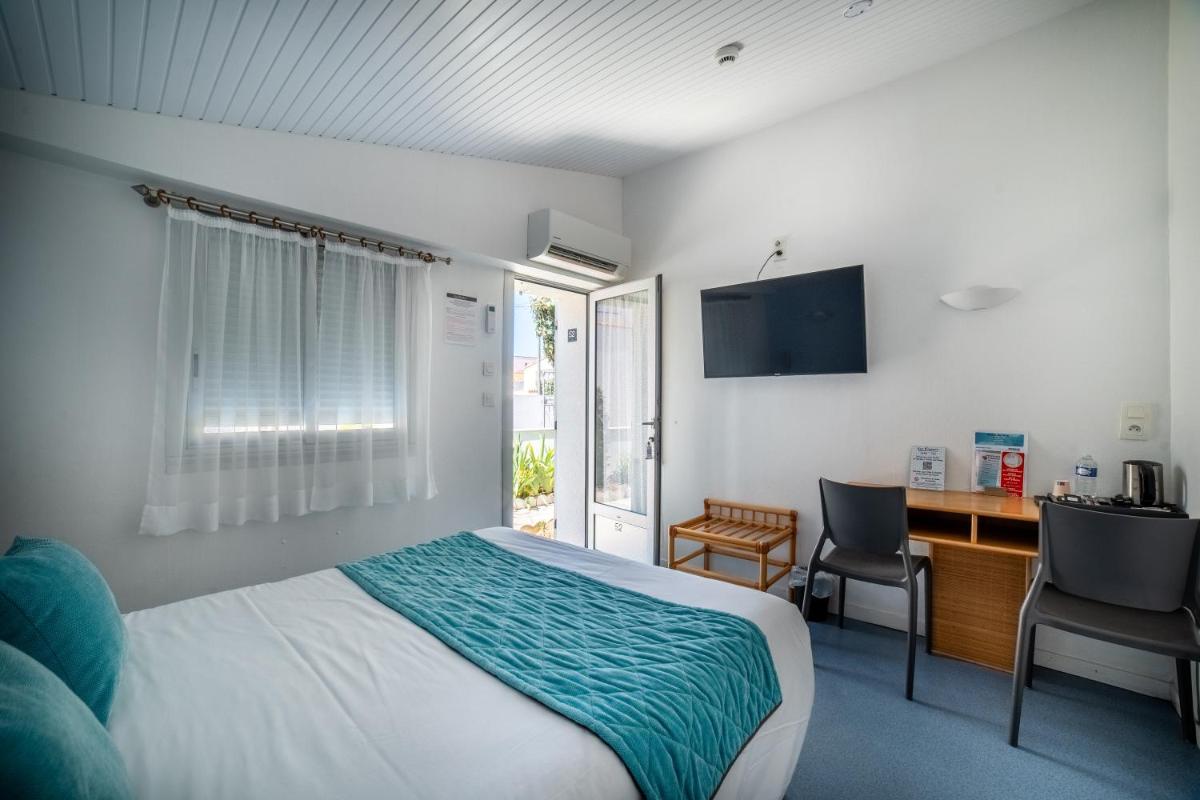 Un ou plusieurs lits dans un hébergement de l'établissement Hotel Les Dunes