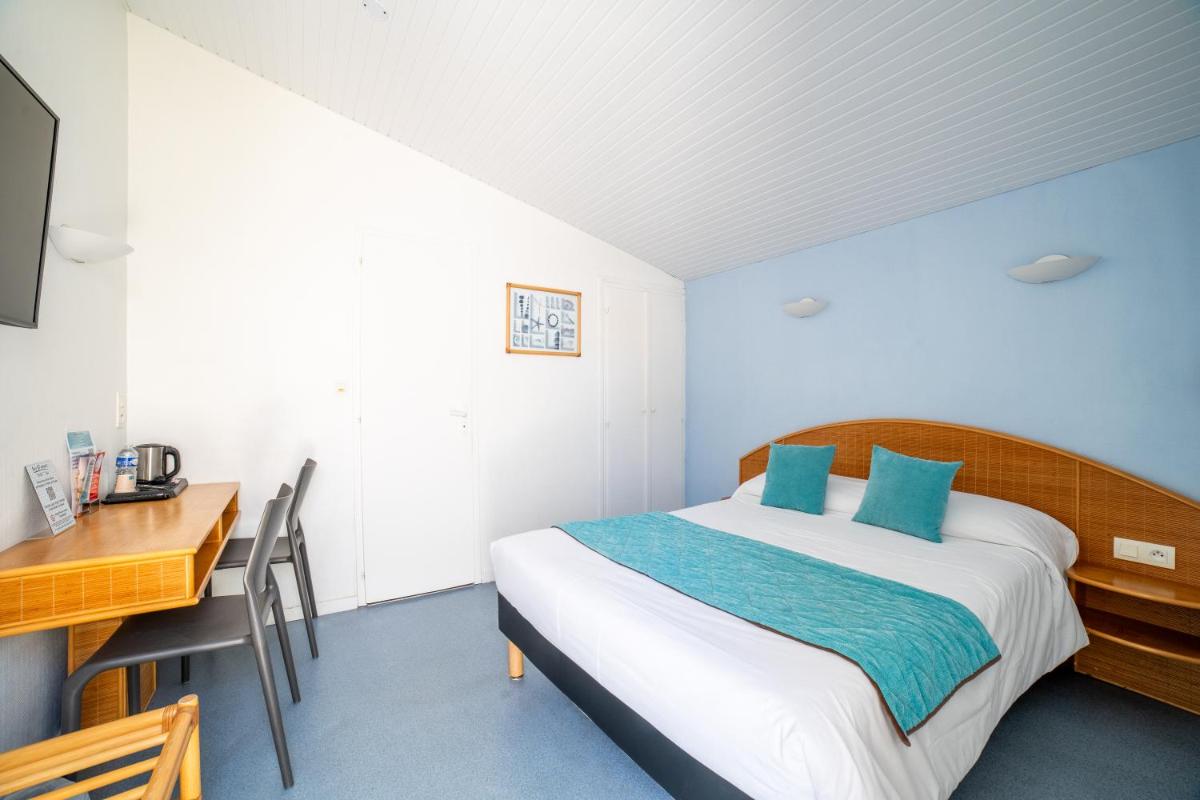 Un ou plusieurs lits dans un hébergement de l'établissement Hotel Les Dunes