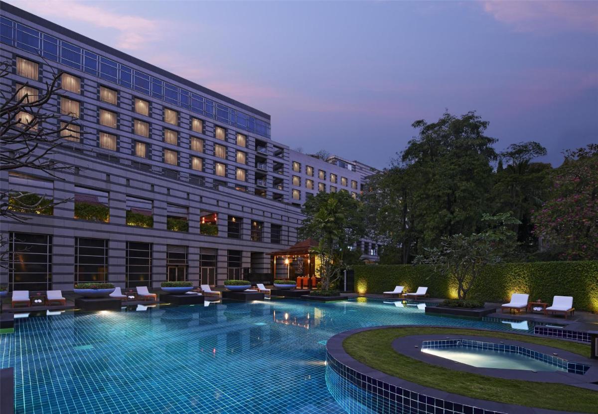 a hotel with a swimming pool in front of a building at Grand Hyatt Mumbai Hotel and Residences in Mumbai