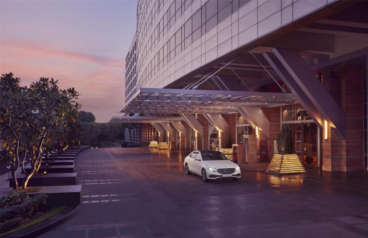 a car parked in a parking lot in front of a building at Grand Hyatt Mumbai Hotel and Residences in Mumbai