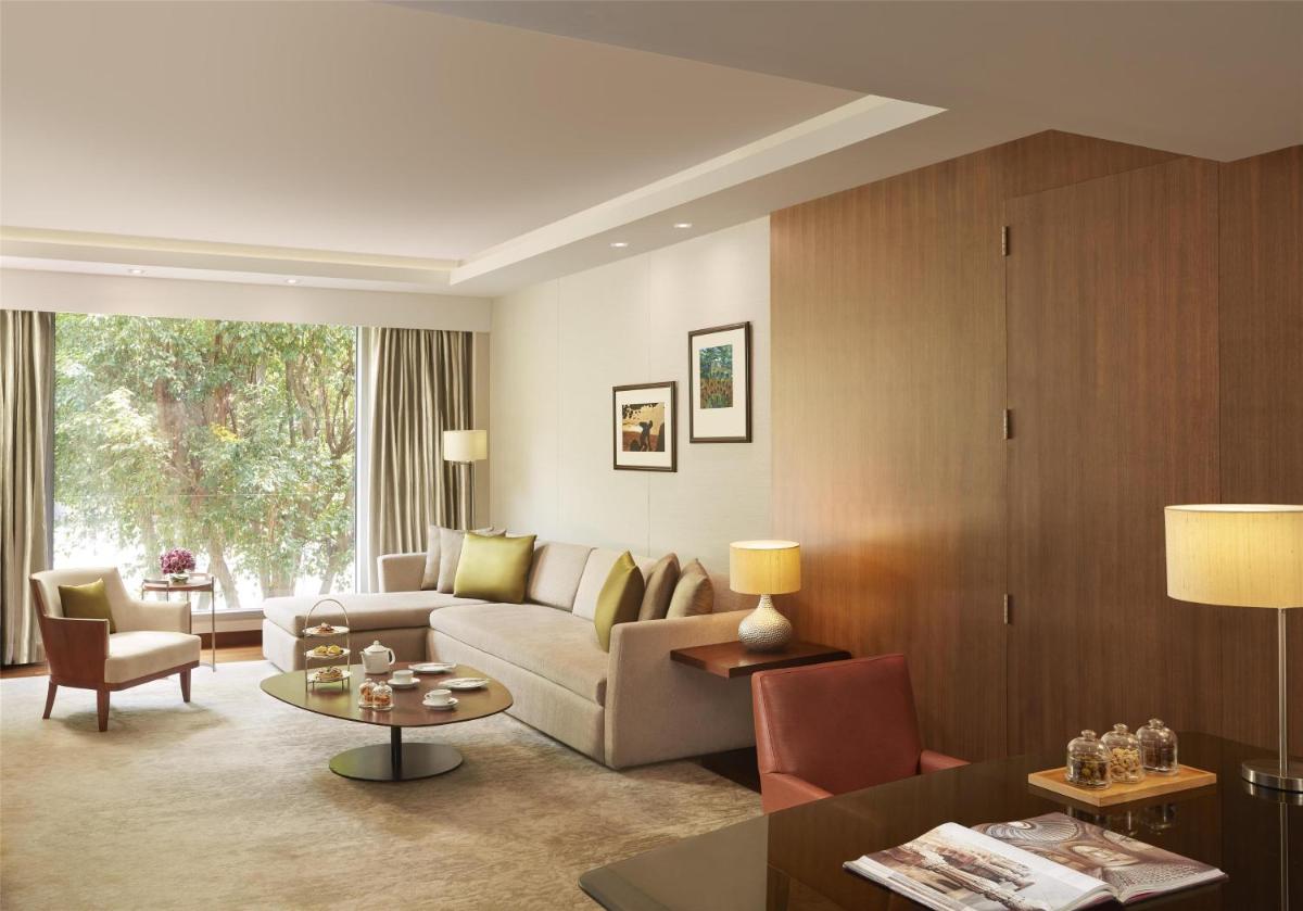 a living room with a couch and a table at Grand Hyatt Mumbai Hotel and Residences in Mumbai