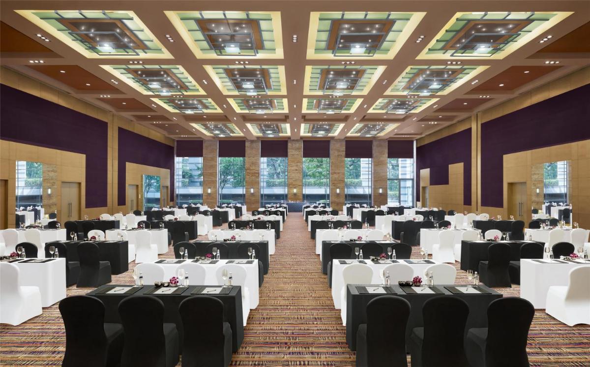 a banquet hall with white tables and chairs at Grand Hyatt Mumbai Hotel and Residences in Mumbai