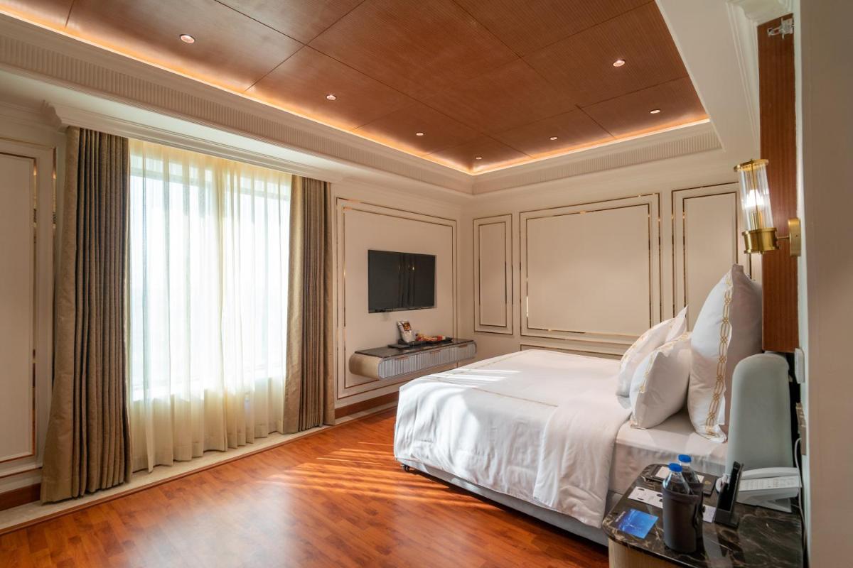 a bedroom with a large bed and a television at The Accord Metropolitan in Chennai