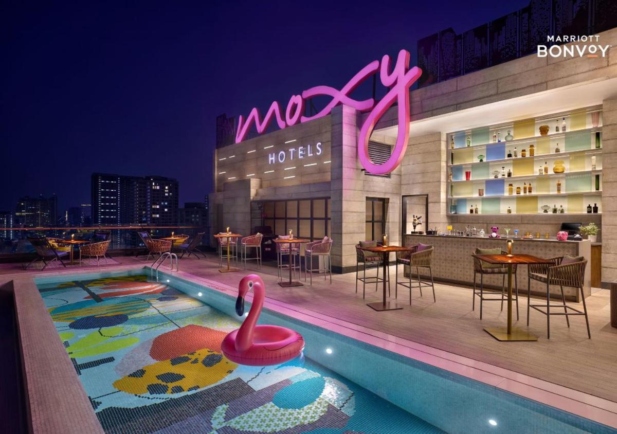 a swimming pool with a swan on the roof of a hotel at Moxy Mumbai Andheri West in Mumbai a swimming pool with a swan on the roof of a hotel at Moxy Mumbai Andheri West in Mumbai