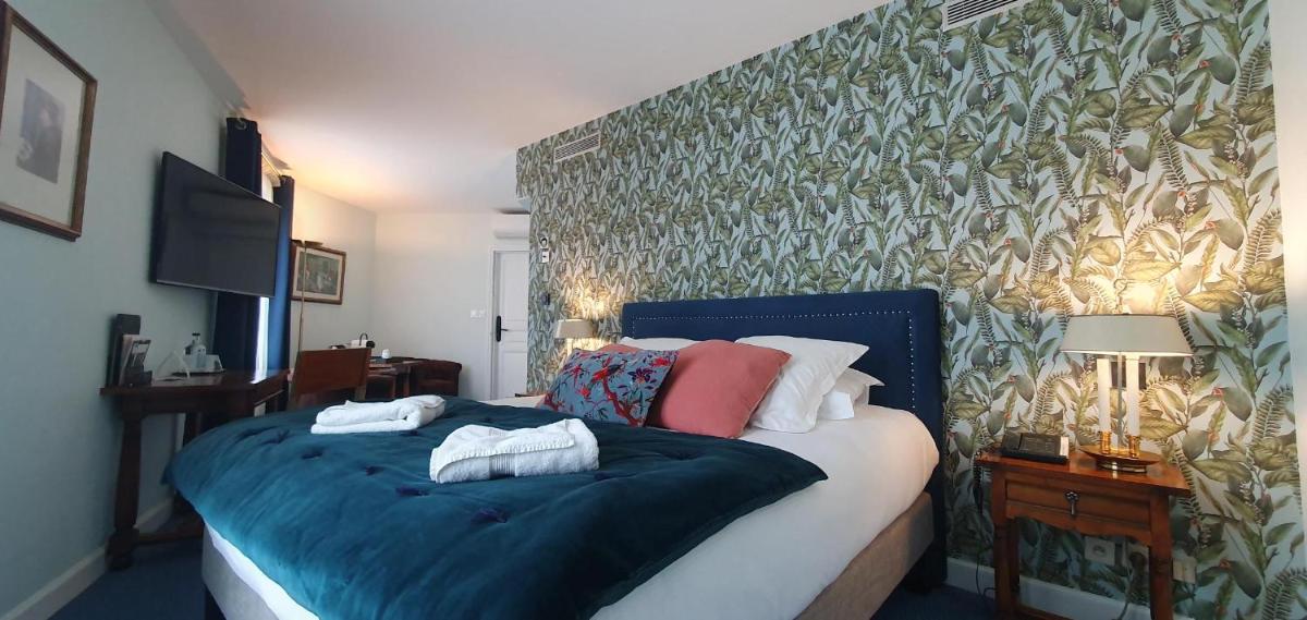 Un ou plusieurs lits dans un hébergement de l'établissement Demeures & Châteaux - Hôtel Greuze & Spa Tournus