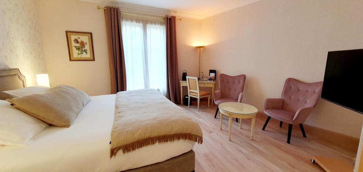 Un ou plusieurs lits dans un hébergement de l'établissement Demeures & Châteaux - Hôtel Greuze & Spa Tournus