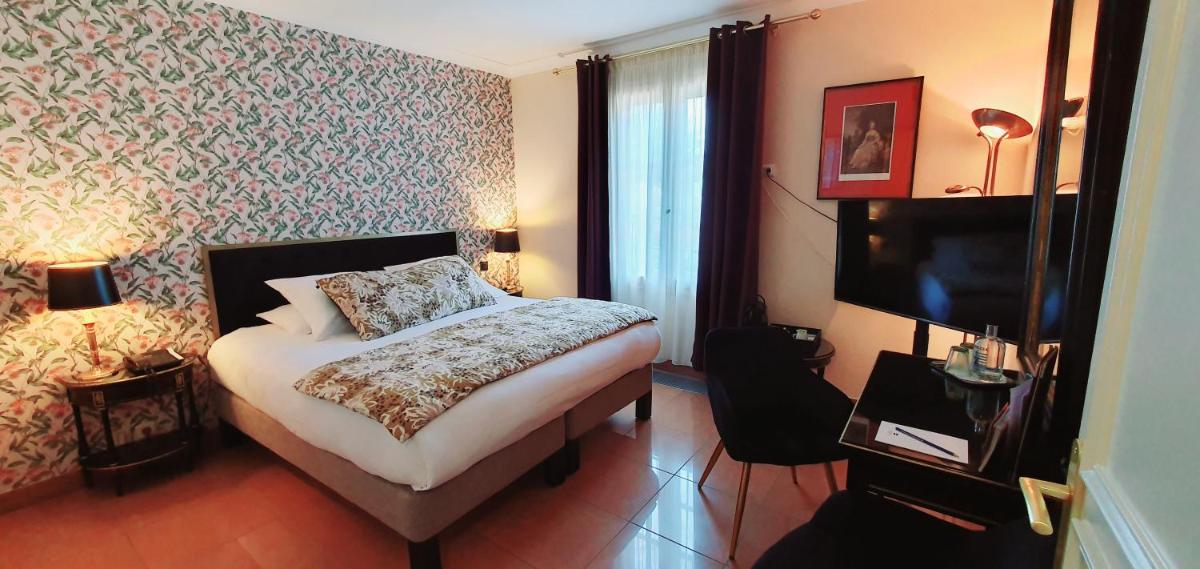 Un ou plusieurs lits dans un hébergement de l'établissement Demeures & Châteaux - Hôtel Greuze & Spa Tournus