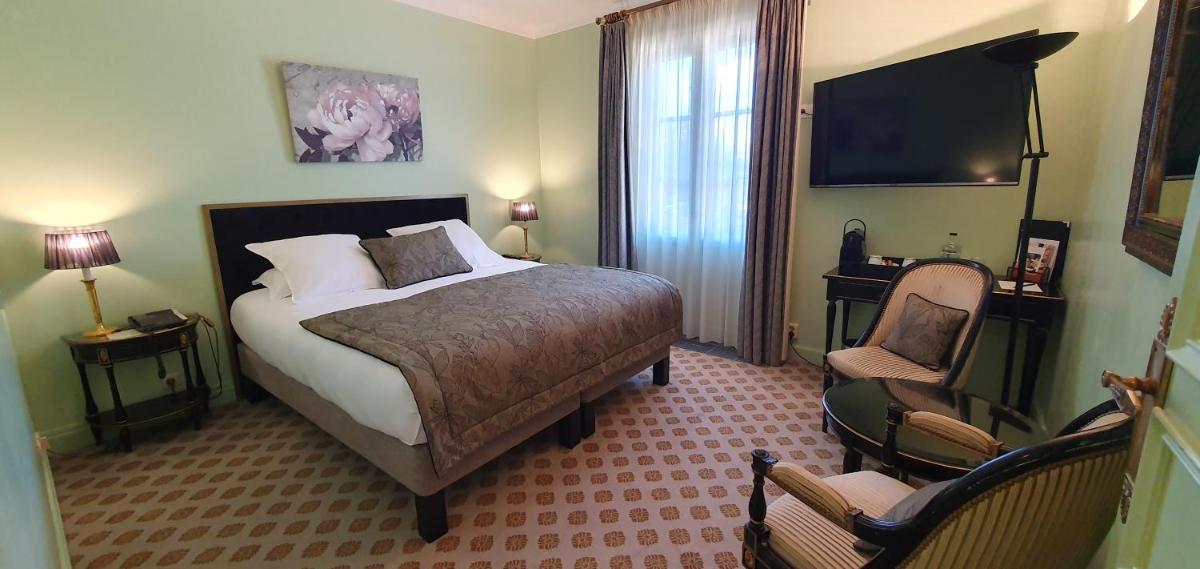 Un ou plusieurs lits dans un hébergement de l'établissement Demeures & Châteaux - Hôtel Greuze & Spa Tournus