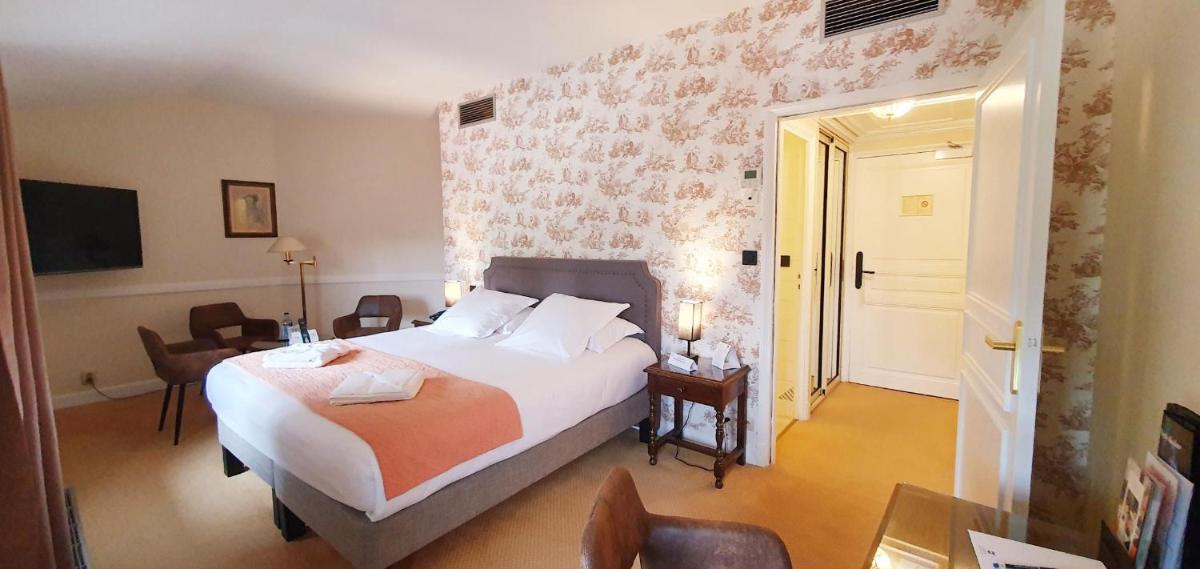 Un ou plusieurs lits dans un hébergement de l'établissement Demeures & Châteaux - Hôtel Greuze & Spa Tournus