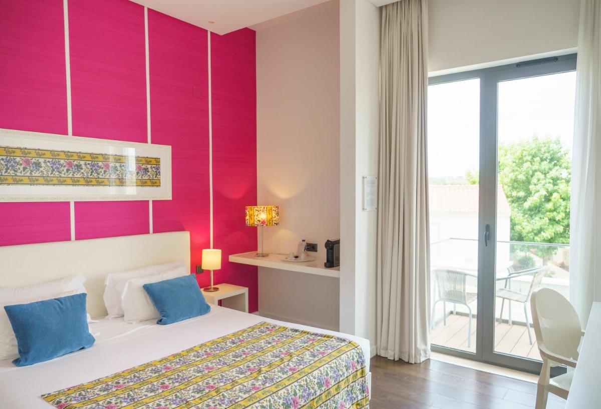 Uma cama ou camas num quarto em Real Abadia, Congress & Spa Hotel