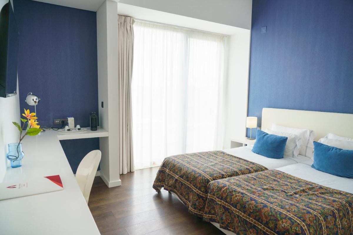 Uma cama ou camas num quarto em Real Abadia, Congress & Spa Hotel