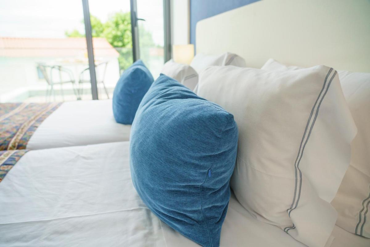 Uma cama ou camas num quarto em Real Abadia, Congress & Spa Hotel