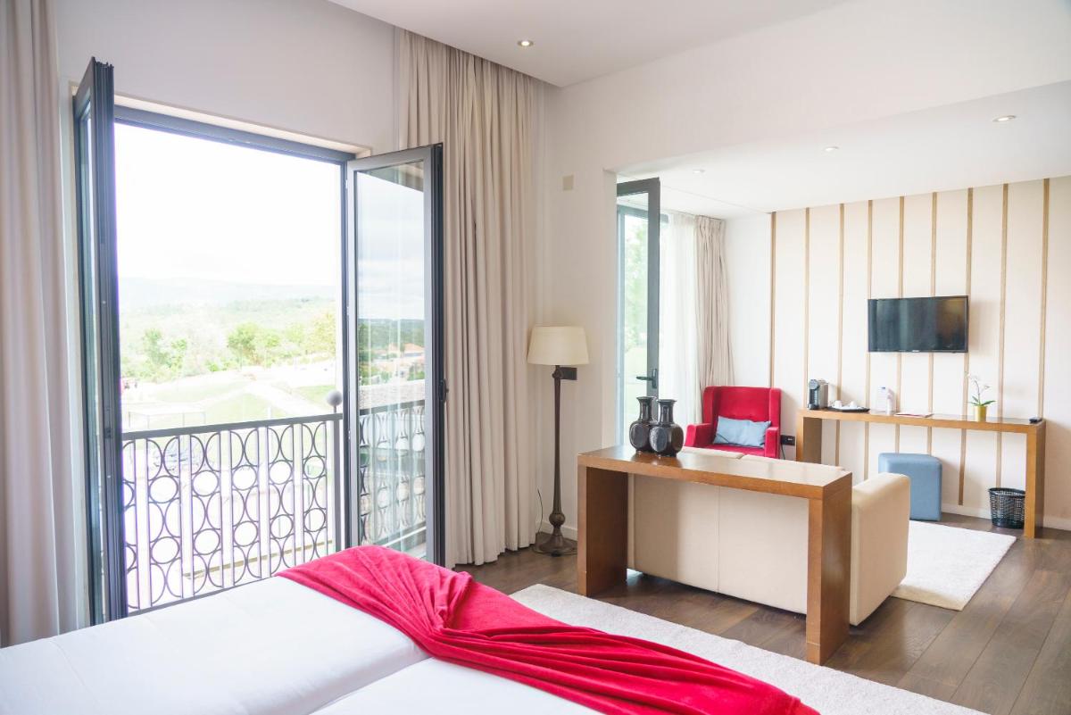 Uma cama ou camas num quarto em Real Abadia, Congress & Spa Hotel