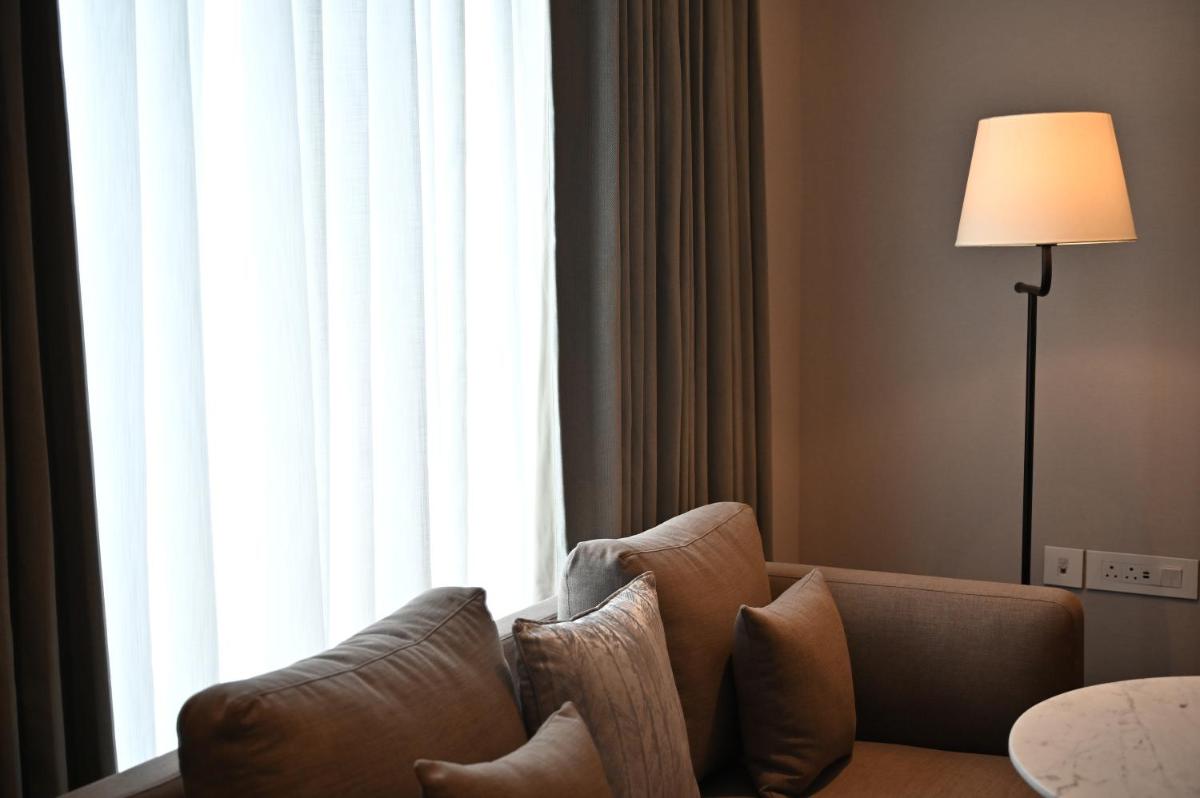 a couch sitting in front of a large window at Holiday Inn New Delhi Mayur Vihar Noida by IHG in New Delhi a couch sitting in front of a large window at Holiday Inn New Delhi Mayur Vihar Noida by IHG in New Delhi