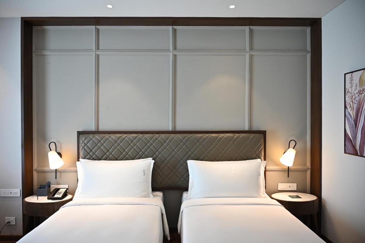 two beds sitting next to each other in a room at Holiday Inn New Delhi Mayur Vihar Noida by IHG in New Delhi two beds sitting next to each other in a room at Holiday Inn New Delhi Mayur Vihar Noida by IHG in New Delhi