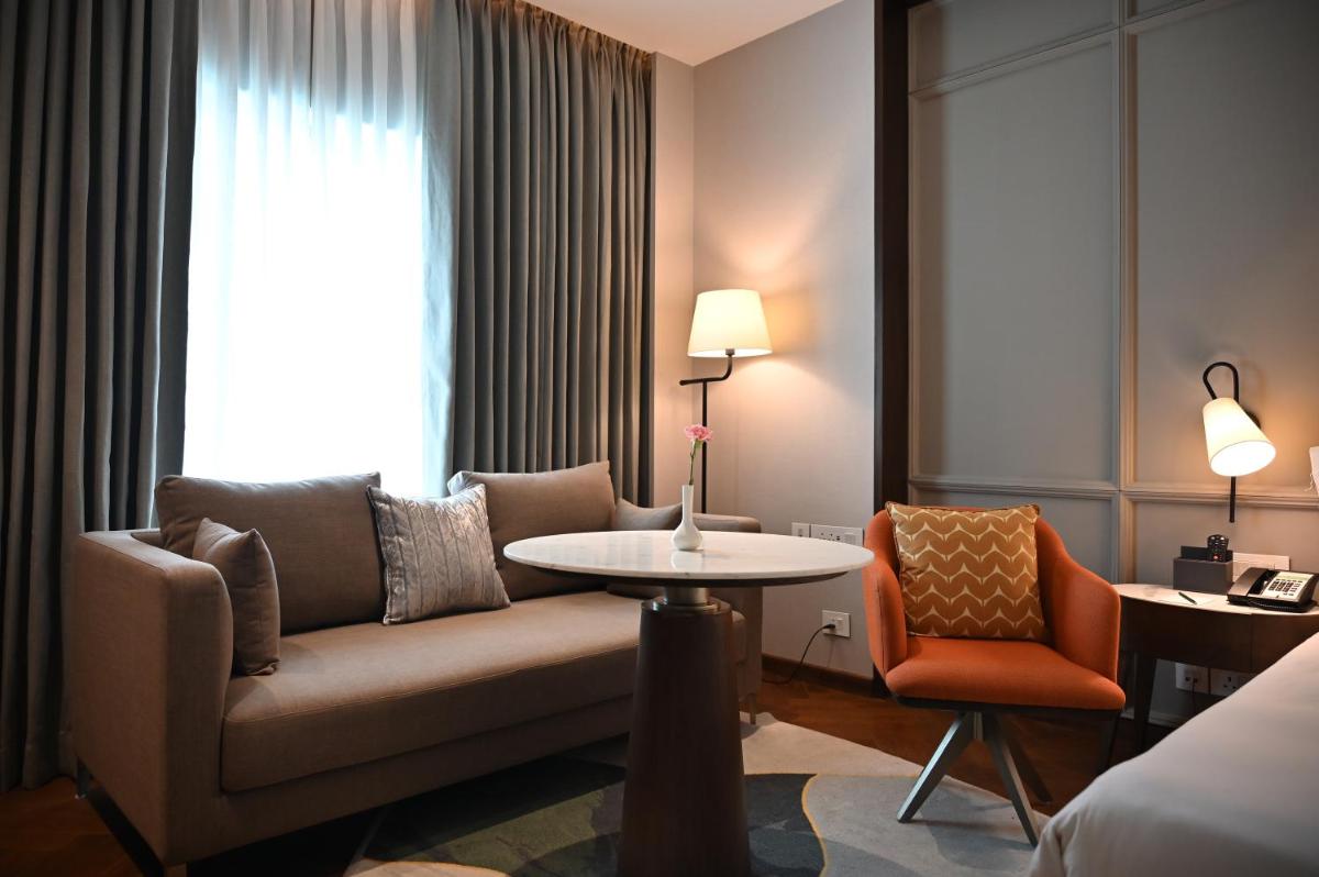 a living room with a couch and a table at Holiday Inn New Delhi Mayur Vihar Noida by IHG in New Delhi a living room with a couch and a table at Holiday Inn New Delhi Mayur Vihar Noida by IHG in New Delhi