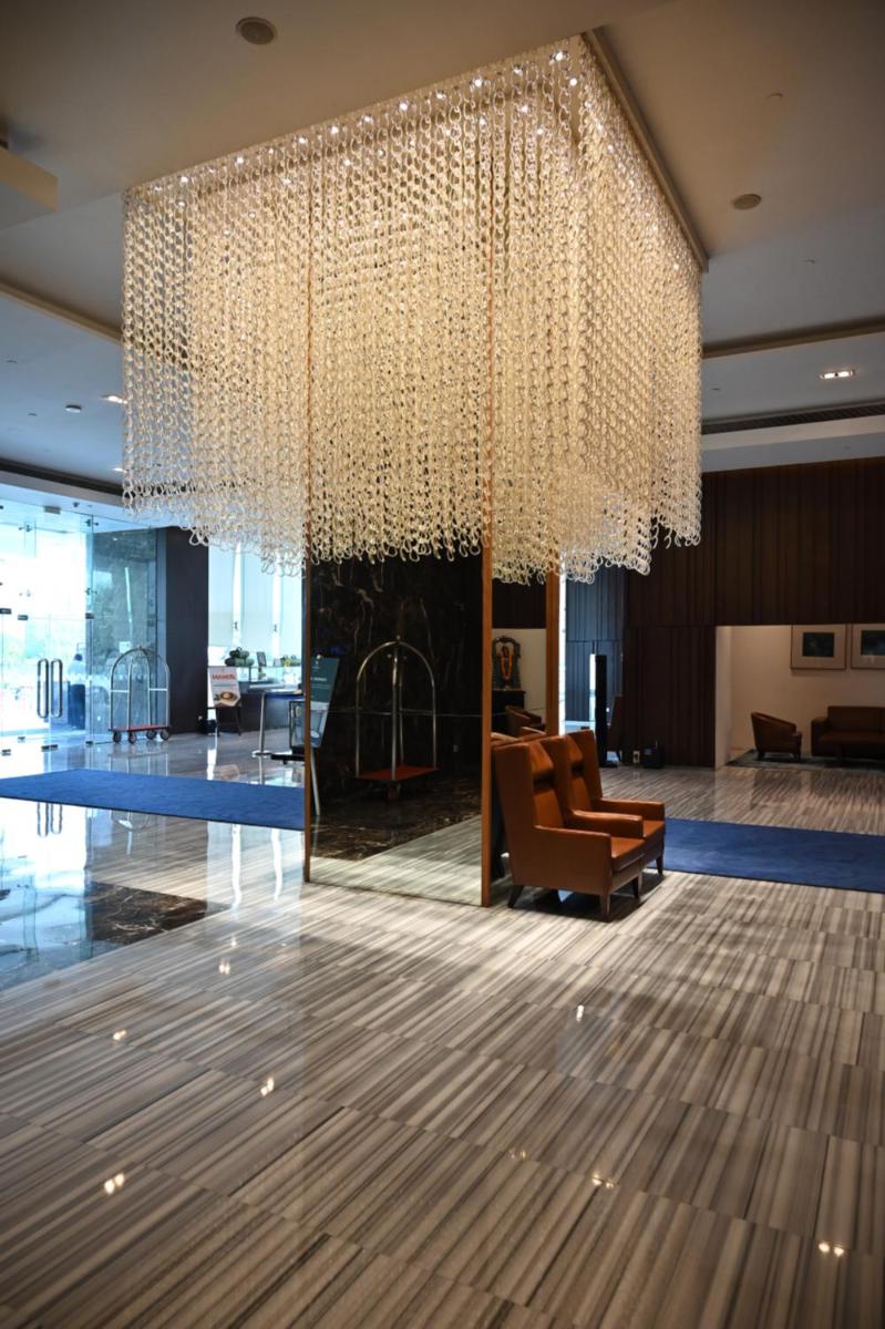 a large chandelier in the lobby of a building at Holiday Inn New Delhi Mayur Vihar Noida by IHG in New Delhi a large chandelier in the lobby of a building at Holiday Inn New Delhi Mayur Vihar Noida by IHG in New Delhi