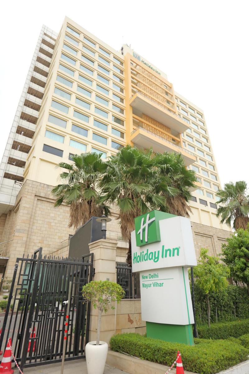 a high fidelity inn sign in front of a building at Holiday Inn New Delhi Mayur Vihar Noida by IHG in New Delhi a high fidelity inn sign in front of a building at Holiday Inn New Delhi Mayur Vihar Noida by IHG in New Delhi