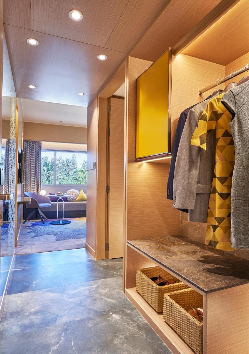 a room with a walk in closet filled with clothes at Vivanta Bengaluru Residency Road in Bengaluru a room with a walk in closet filled with clothes at Vivanta Bengaluru Residency Road in Bengaluru