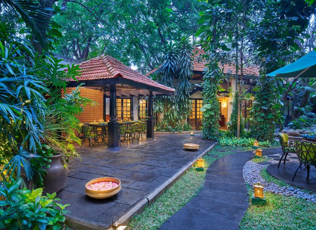 a house with a patio with tables and chairs at Vivanta Bengaluru Residency Road in Bengaluru a house with a patio with tables and chairs at Vivanta Bengaluru Residency Road in Bengaluru