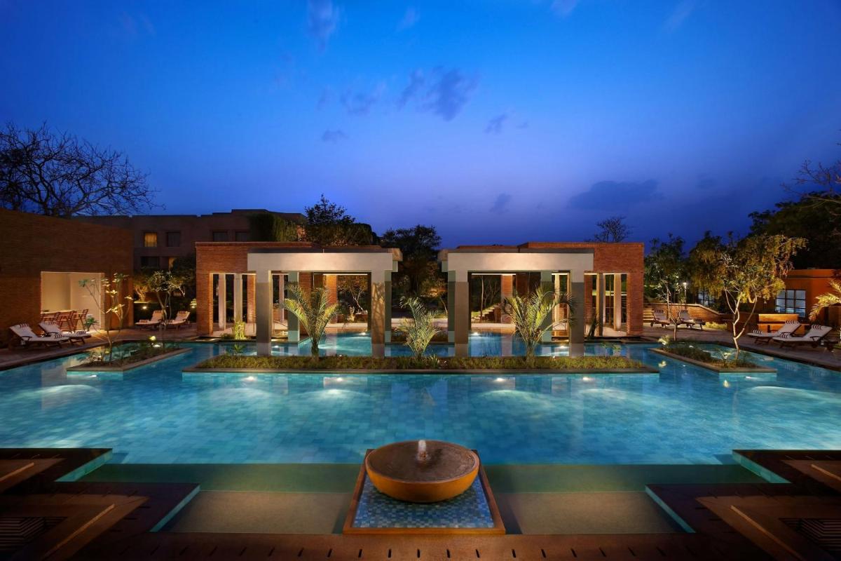a large swimming pool at night with a building at ITC Mughal, A Luxury Collection Resort & Spa, Agra in Agra