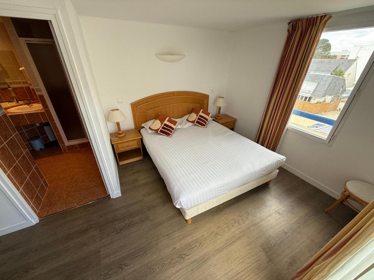 Un ou plusieurs lits dans un hébergement de l'établissement Hôtel Édenia - Spa Estime&Sens