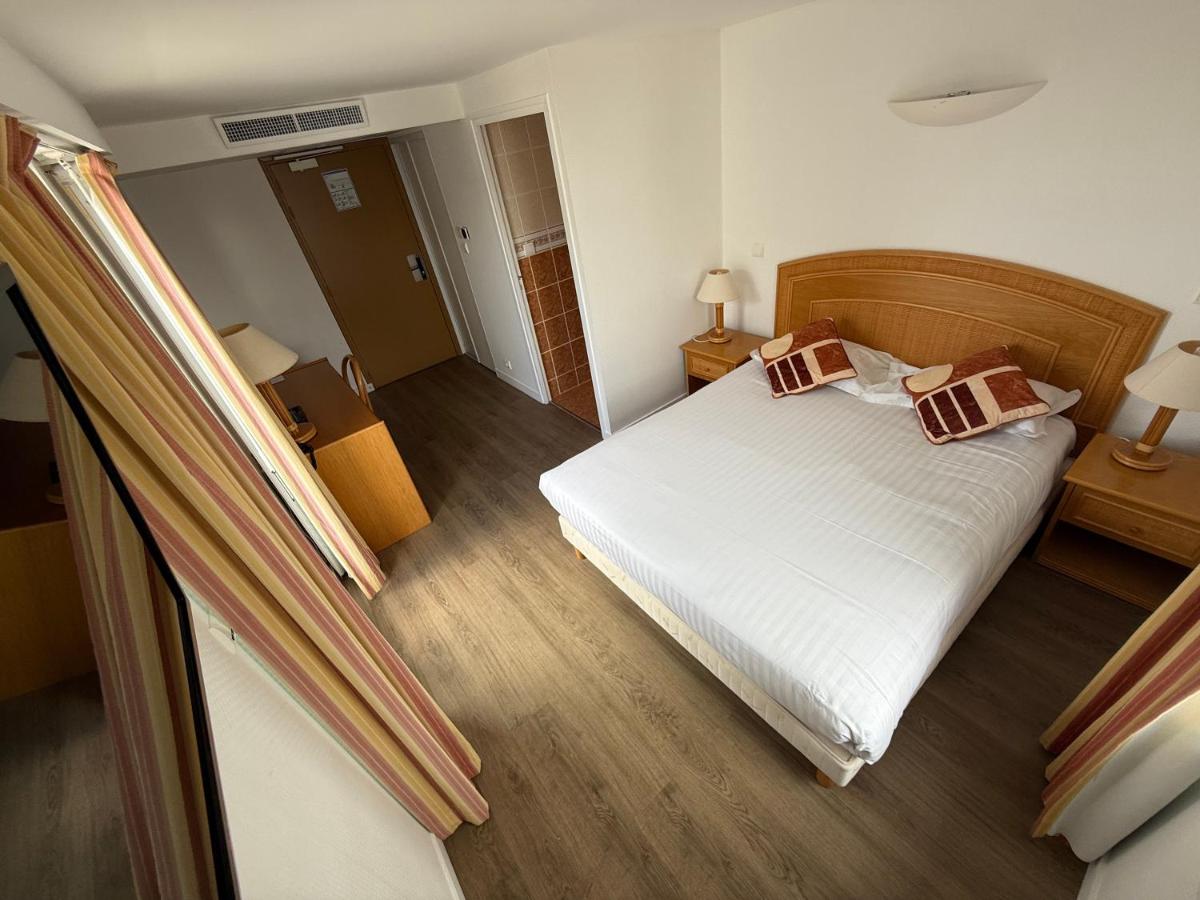 Un ou plusieurs lits dans un hébergement de l'établissement Hôtel Édenia - Spa Estime&Sens