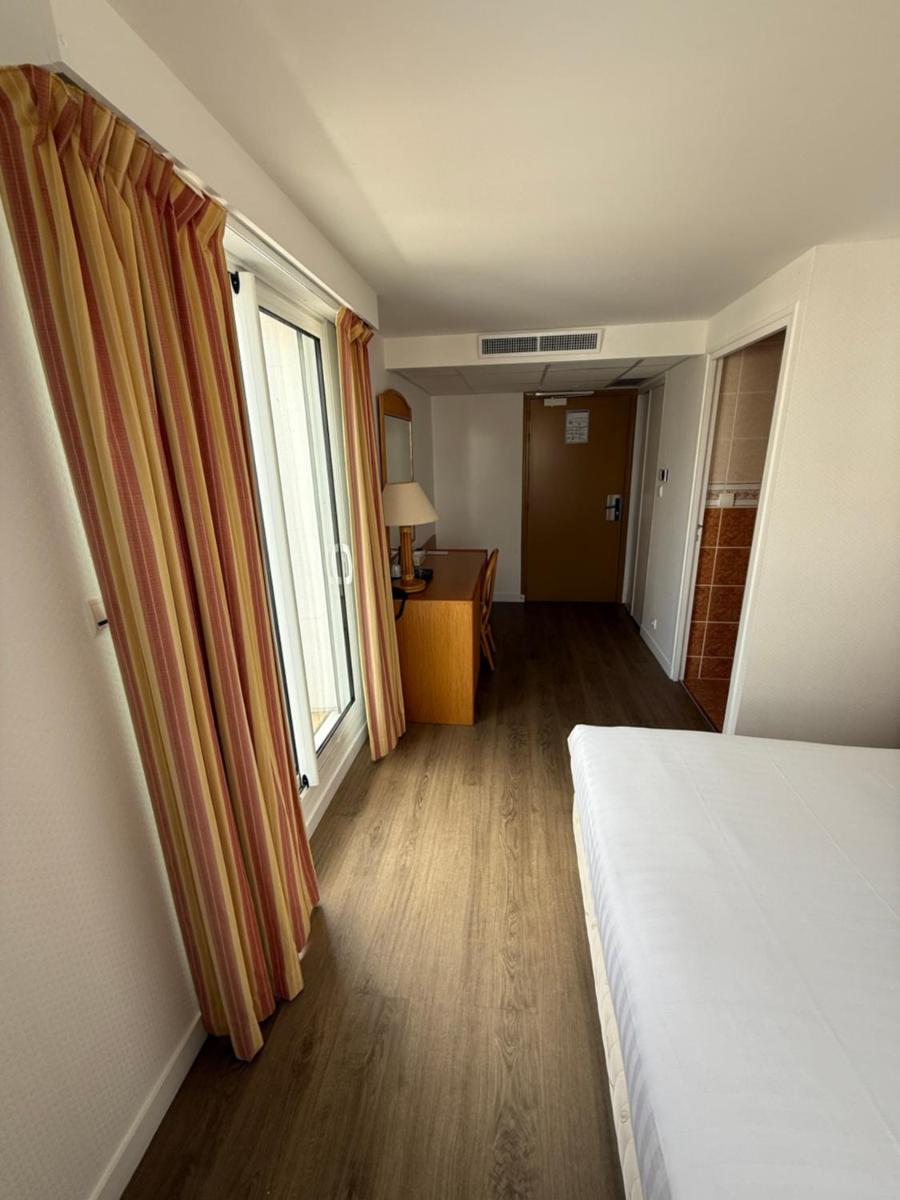 Un ou plusieurs lits dans un hébergement de l'établissement Hôtel Édenia - Spa Estime&Sens