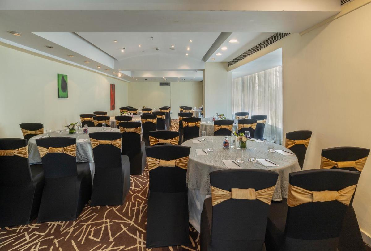 a conference room with tables and chairs in it at Vivanta Bengaluru, Whitefield in Bengaluru +68 photos
