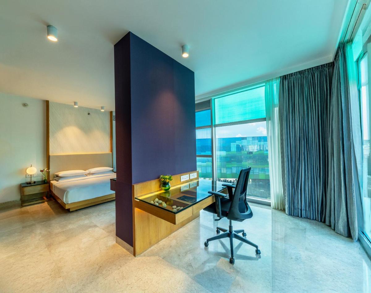 an office with a desk and a chair in a room at Vivanta Bengaluru, Whitefield in Bengaluru