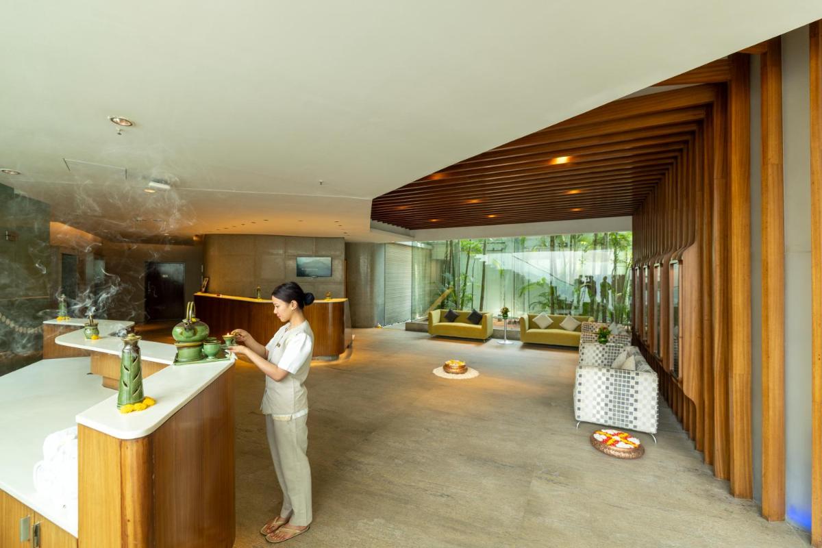 a woman standing at a sink in a kitchen at Vivanta Bengaluru, Whitefield in Bengaluru
