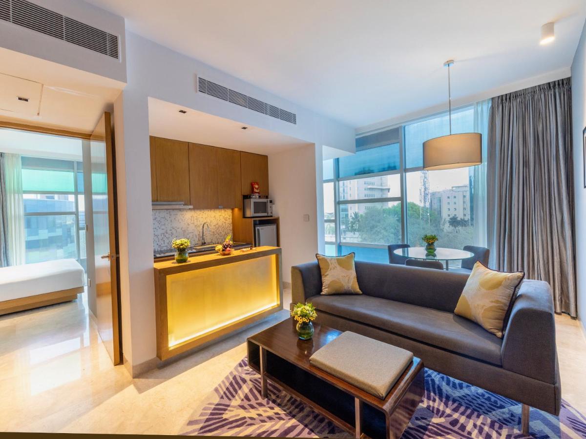 a living room with a couch and a table at Vivanta Bengaluru, Whitefield in Bengaluru