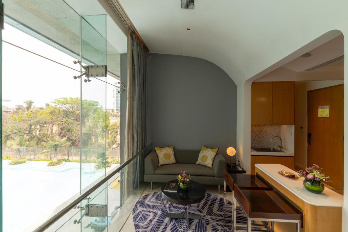 a living room with a couch and a table at Vivanta Bengaluru, Whitefield in Bengaluru