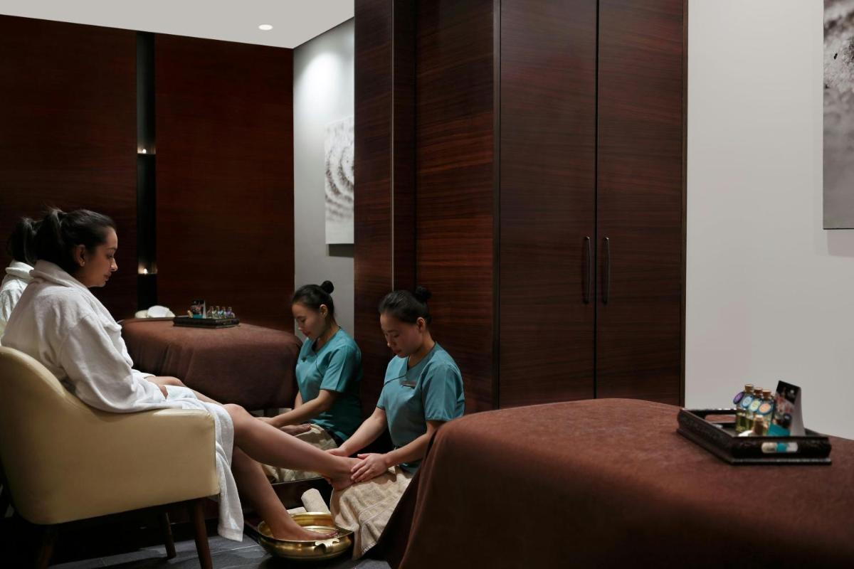 a group of people sitting around a table in a room at Courtyard by Marriott Pune Hinjewadi in Pune