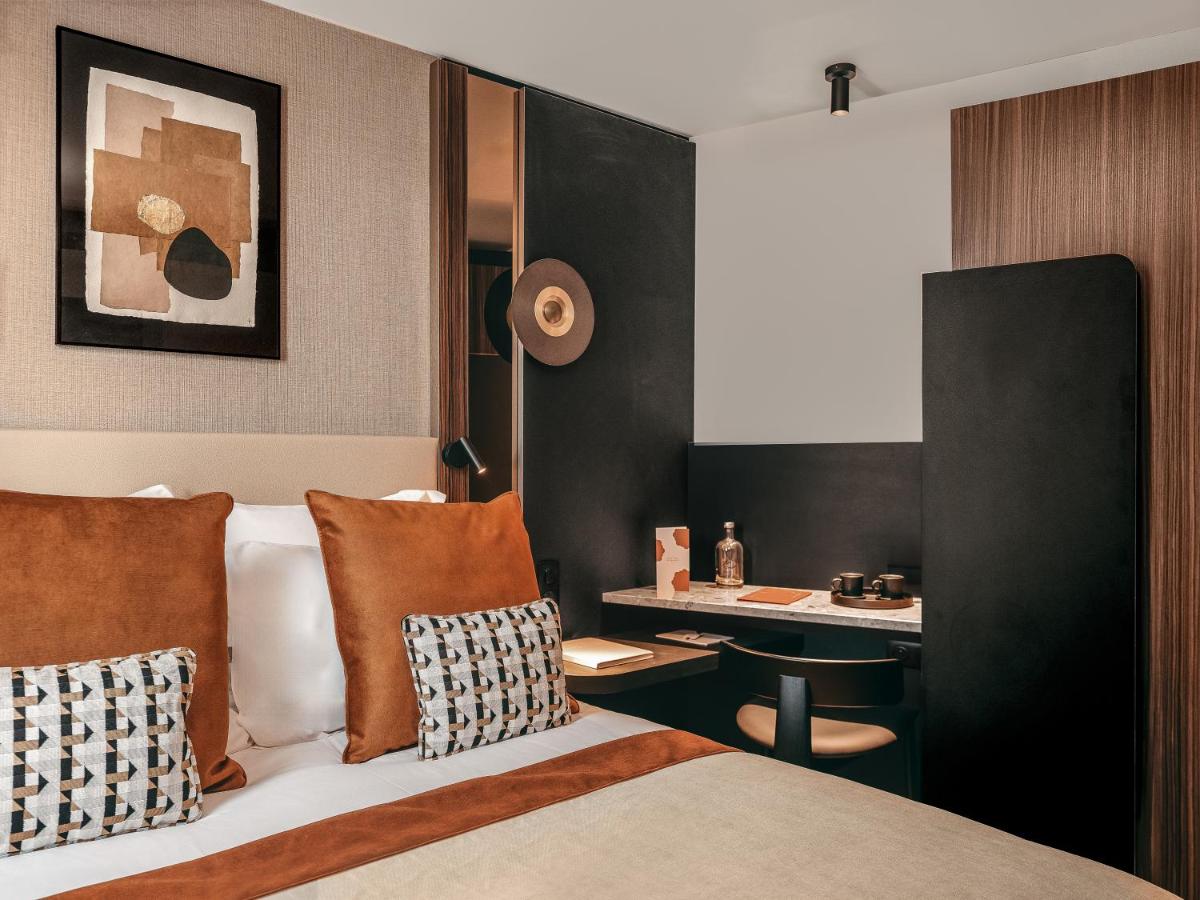 Un ou plusieurs lits dans un hébergement de l'établissement Hôtel Barnett Paris