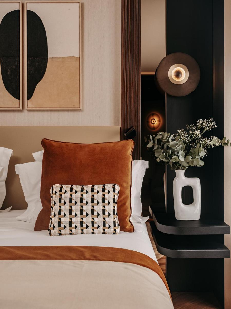 Un ou plusieurs lits dans un hébergement de l'établissement Hôtel Barnett Paris
