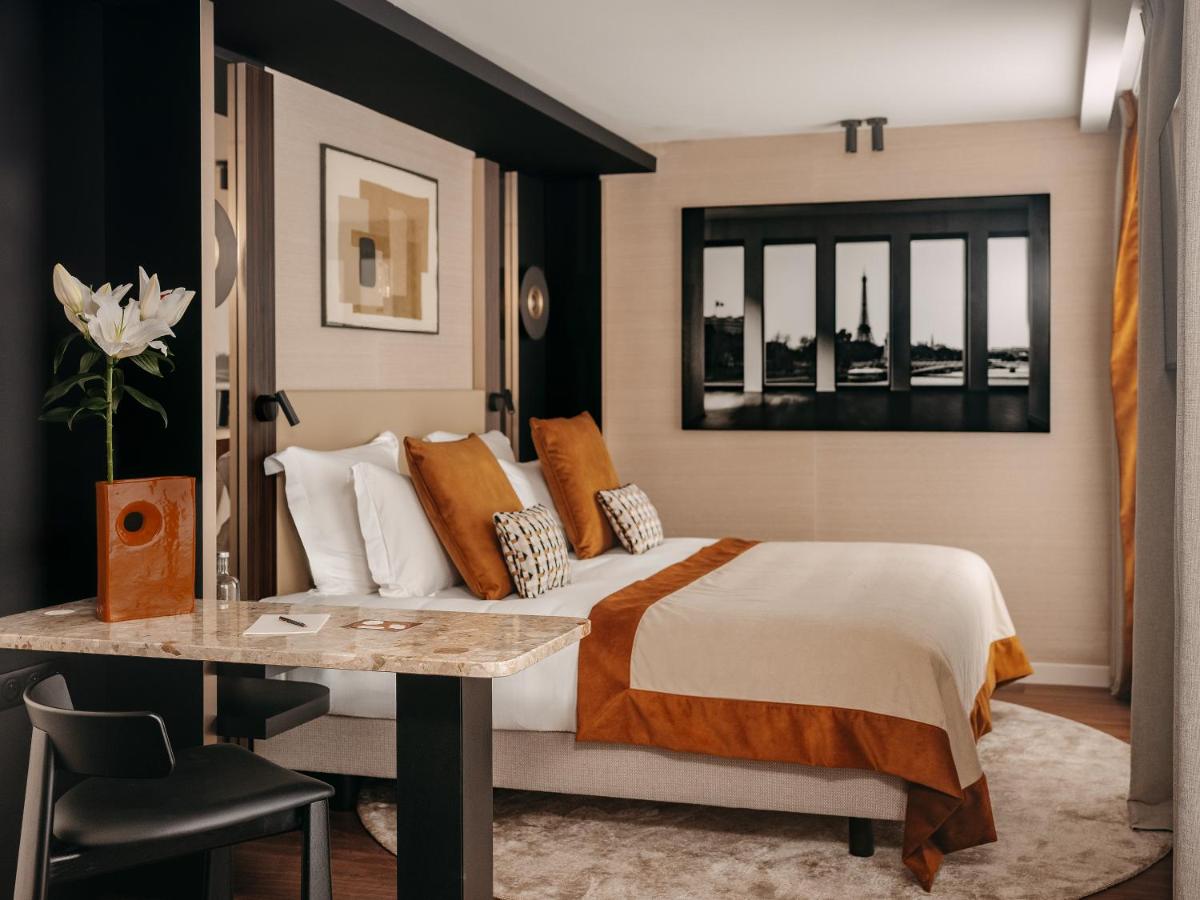 Un ou plusieurs lits dans un hébergement de l'établissement Hôtel Barnett Paris