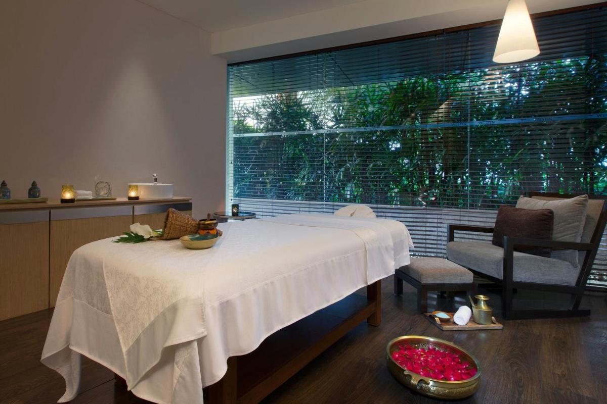 a room with a bed and a large window at The Westin Mumbai Garden City in Mumbai