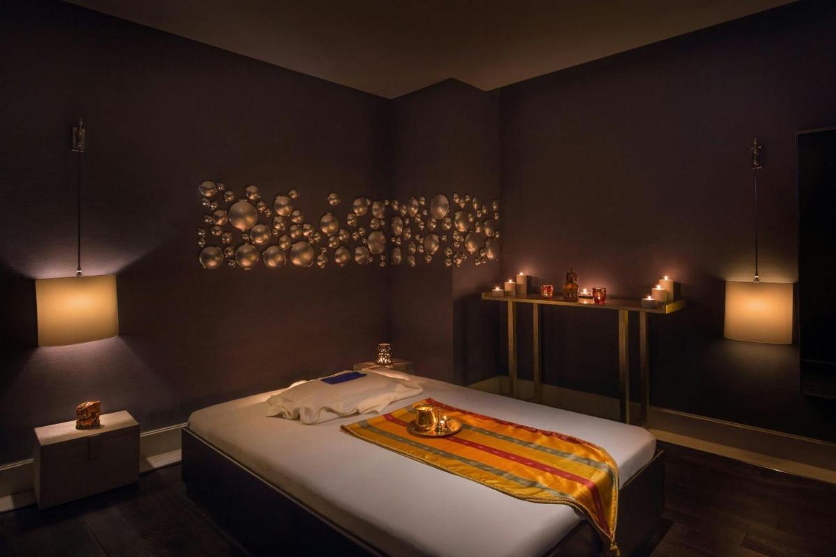 a bedroom with a bed with candles on it at ITC Kakatiya, a Luxury Collection Hotel, Hyderabad in Hyderabad