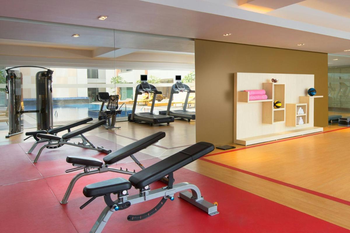 a gym with several exercise bikes in a room at Sheraton Hyderabad Hotel in Hyderabad