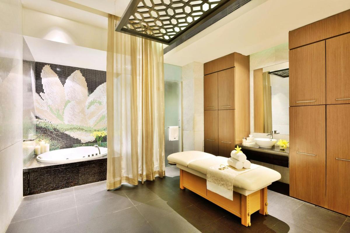 a bathroom with two sinks and a bath tub at The Westin Hyderabad Mindspace in Hyderabad