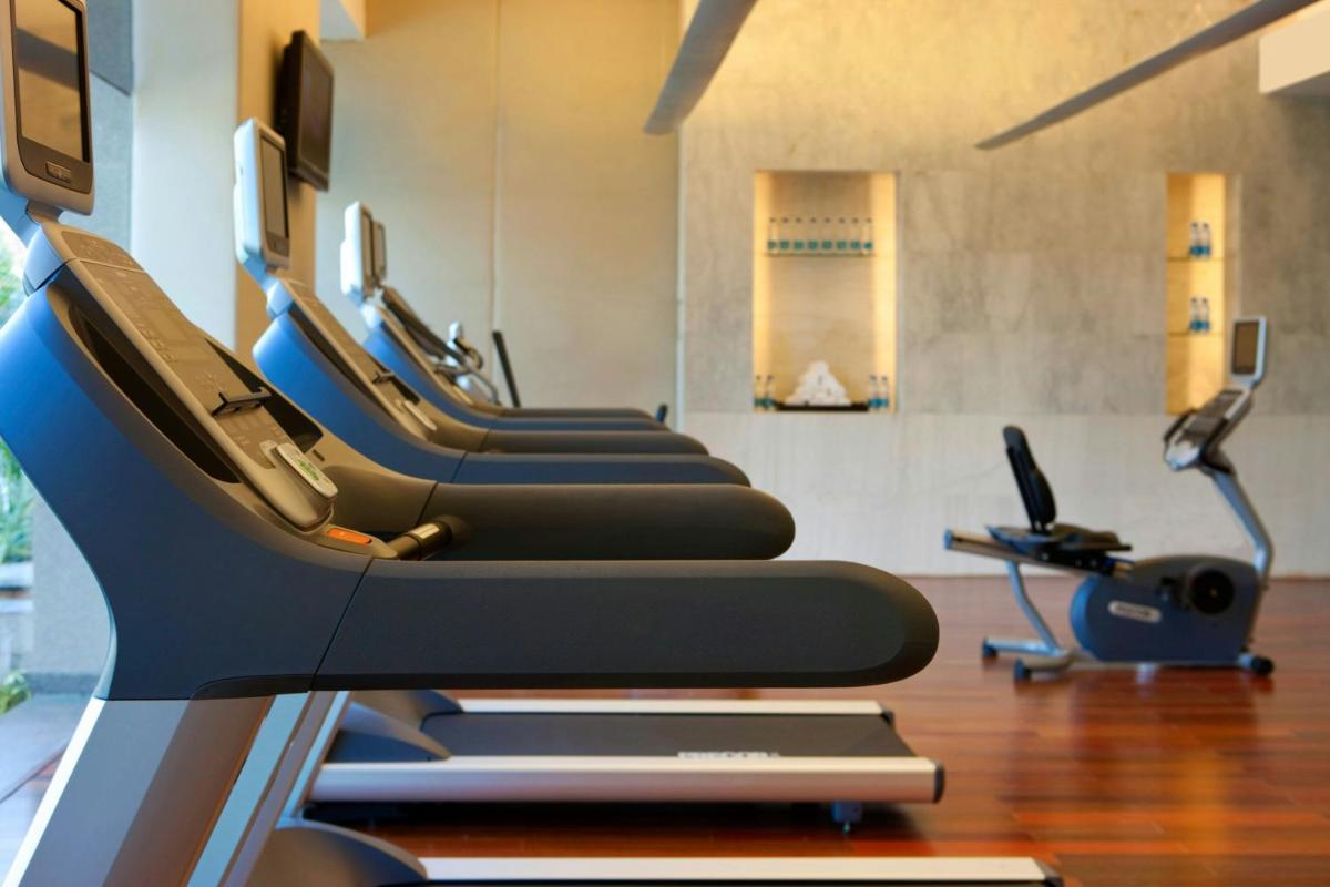 a row of treadmills in a gym at The Westin Hyderabad Mindspace in Hyderabad