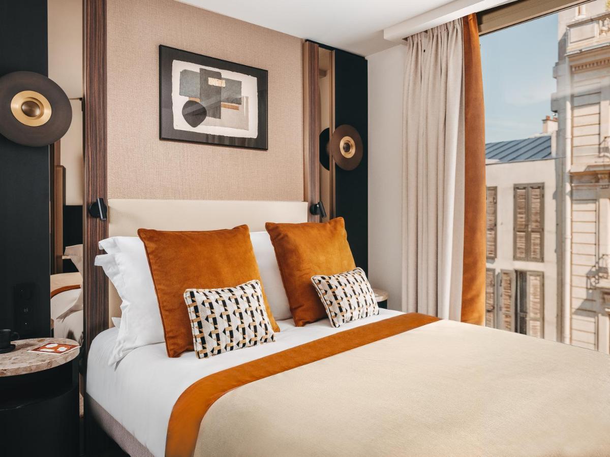 Un ou plusieurs lits dans un hébergement de l'établissement Hôtel Barnett Paris