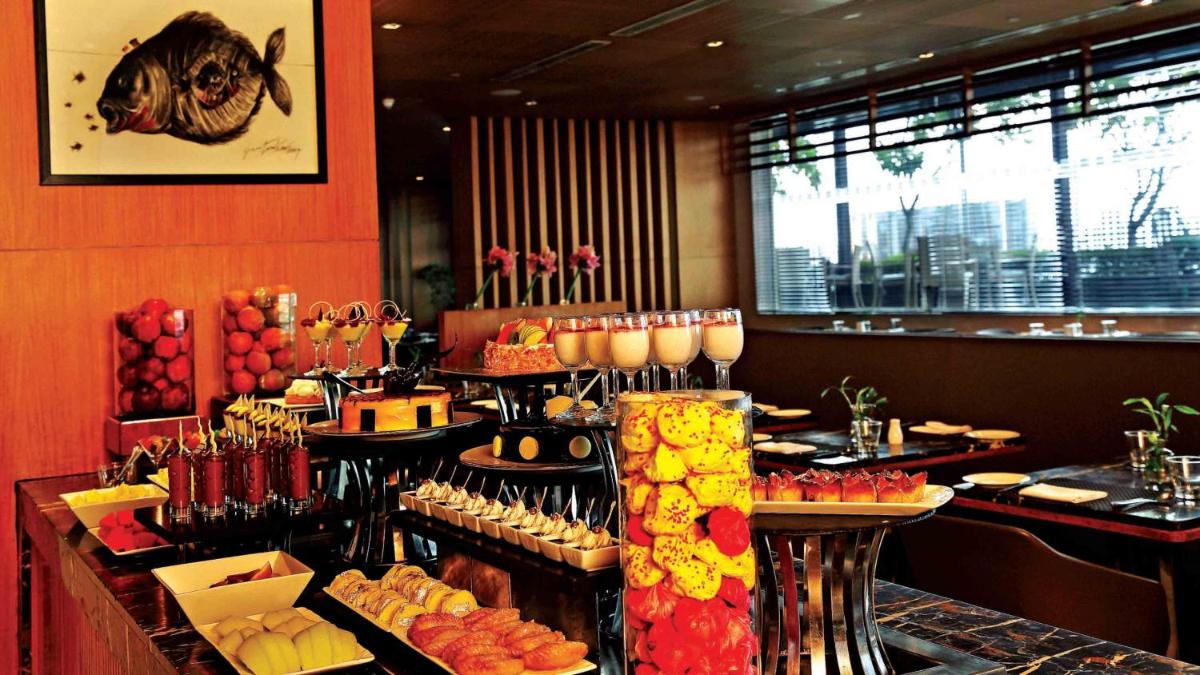 a restaurant with a buffet of food on display at Holiday Inn New Delhi Mayur Vihar Noida by IHG in New Delhi a restaurant with a buffet of food on display at Holiday Inn New Delhi Mayur Vihar Noida by IHG in New Delhi