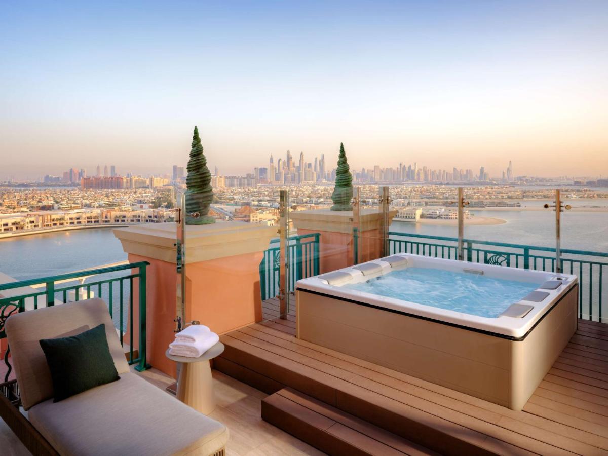 a hot tub on a balcony with a view of the city at Atlantis, The Palm in Dubai