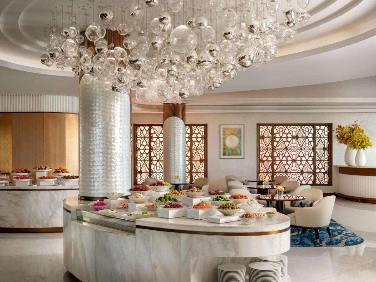 a buffet in a hotel lobby with a table of food at Atlantis, The Palm in Dubai