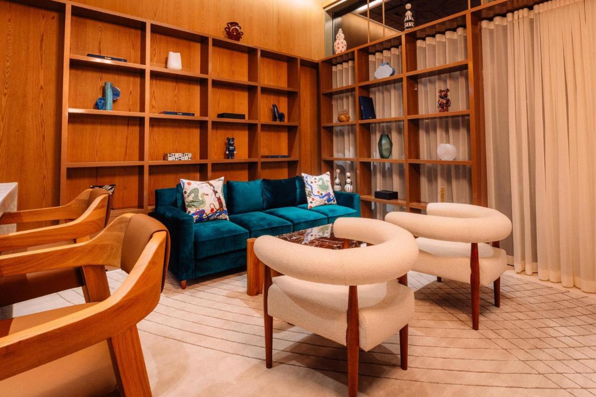 a living room with a couch and chairs and shelves at Atlantis, The Palm in Dubai