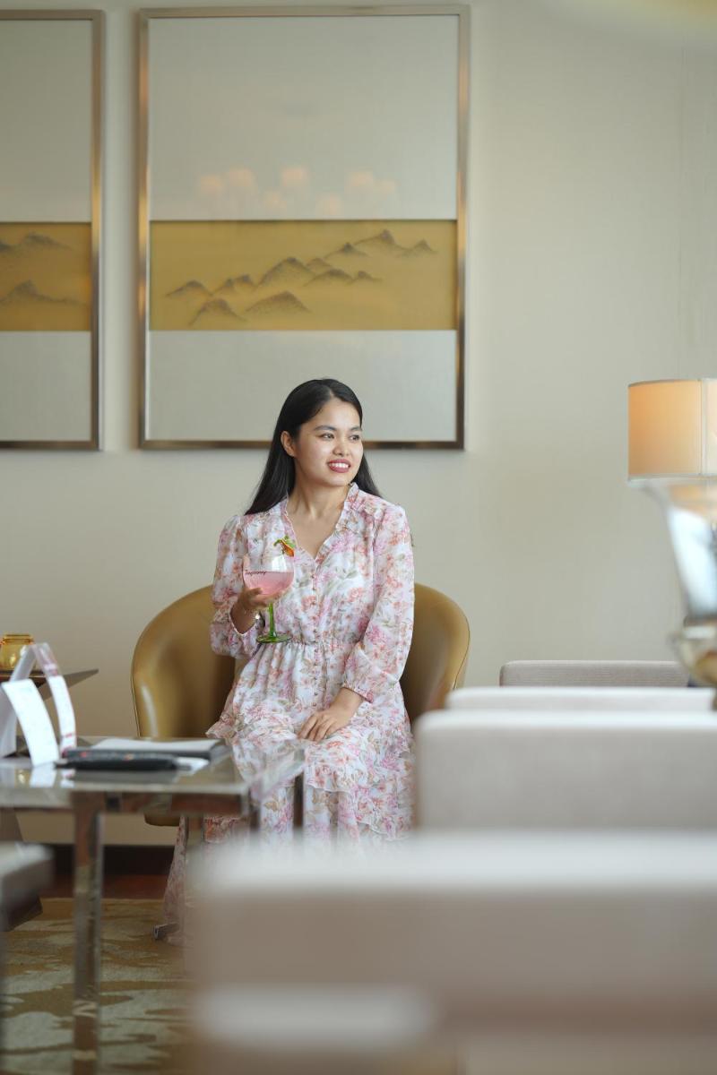 a woman sitting in a chair in a room at Kochi Marriott Hotel in Cochin