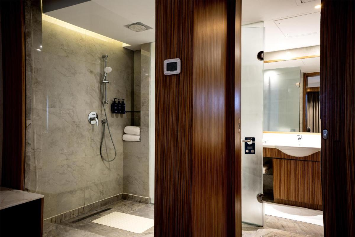 a bathroom with a shower and a sink at Radisson Blu Hotel Amritsar in Amritsar