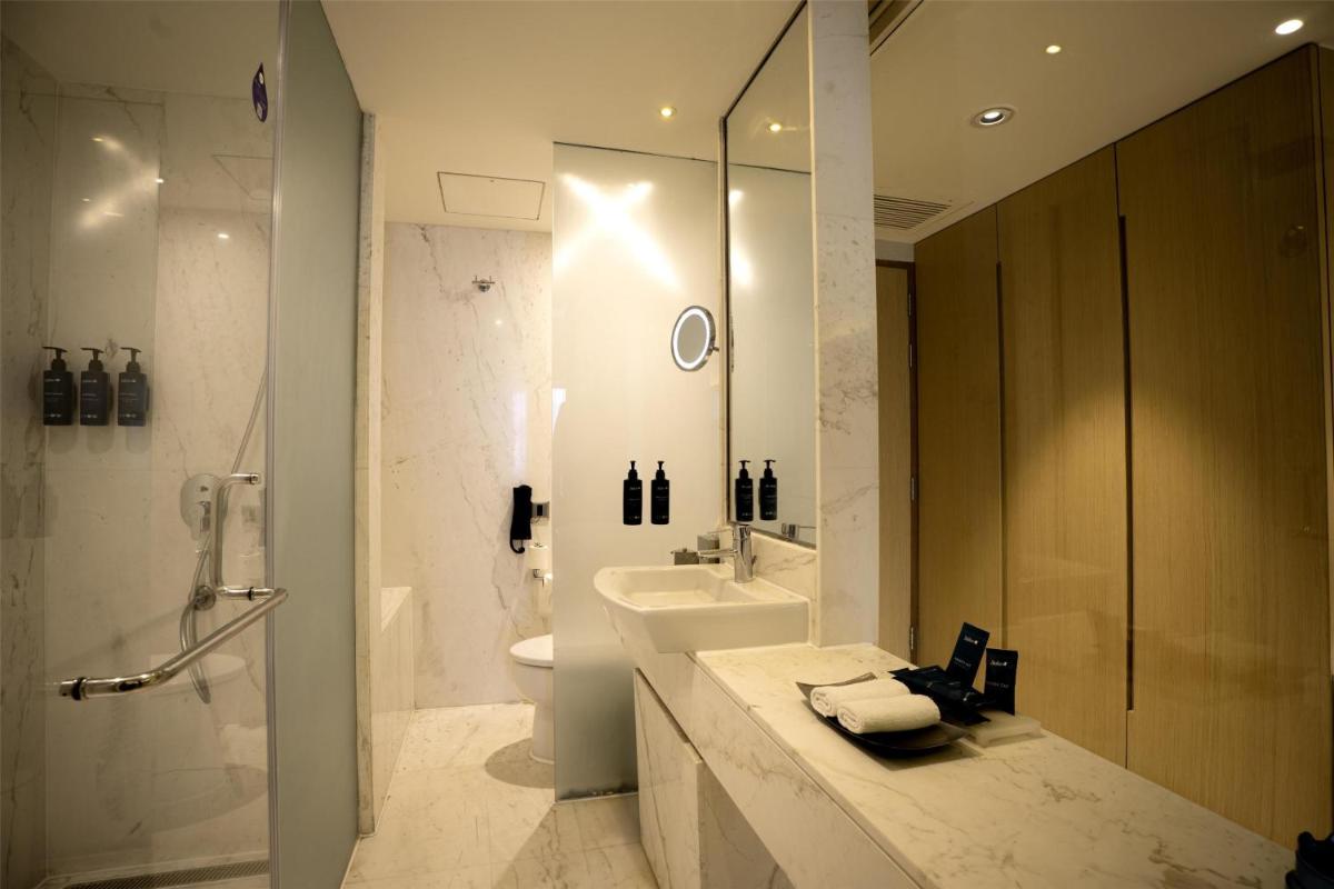 a bathroom with a sink and a toilet and a shower at Radisson Blu Hotel Amritsar in Amritsar